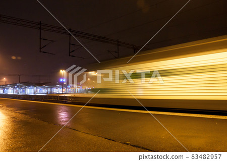 Train in motion on the station at night, long exposure photo. Train in motion on the station at night, long exposure photo. 83482957