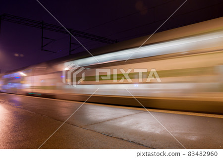 Train in motion on the station at night, long exposure photo. Train in motion on the station at night, long exposure photo. 83482960