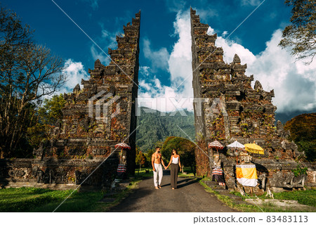 Traveling couple in Bali. Happy couple vacationing in Asian countries. Couple at the Bali gate. A man and a woman traveling on the island of Bali Indonesia. The couple is traveling in Indonesia 83483113