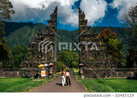 Traveling couple in Bali. Happy couple vacationing in Asian countries. Couple at the Bali gate. A man and a woman traveling on the island of Bali Indonesia. The couple is traveling in Indonesia Traveling couple in Bali. Happy couple vacationing in Asian countries. Couple at the Bali gate. A man and a woman traveling on the island of Bali Indonesia. The couple is traveling in Indonesia 83483119