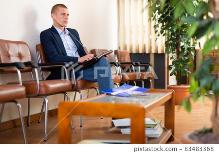 Man with briefcase waiting for job interview at office Man with briefcase waiting for job interview at office 83483368