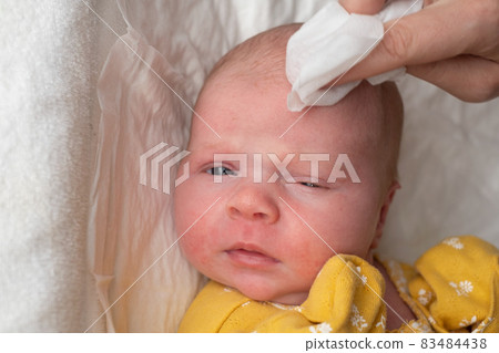 Cleaning baby's face on the morning. Hygiene procedures for the baby Cleaning baby's face on the morning. Hygiene procedures for the baby 83484438