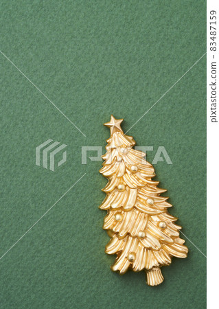 Golden miniature Christmas tree with green background 83487159