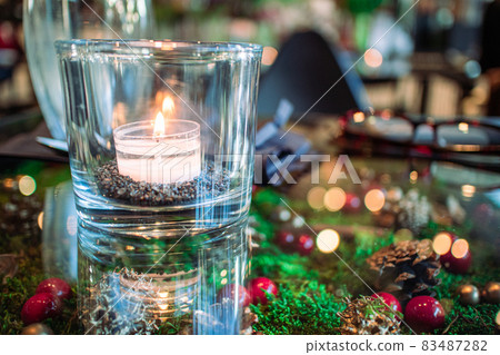 Table and candles 83487282
