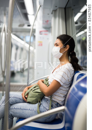 Woman in face mask in subway train Woman in face mask in subway train 83487985