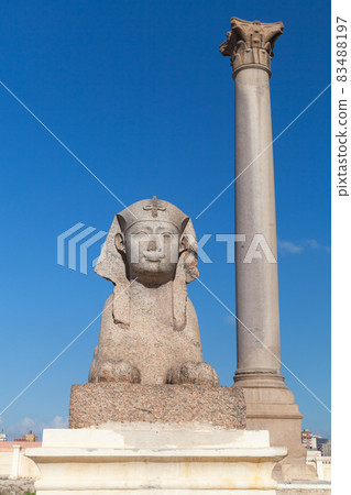 Ancient sphinx and Pompeys Pillar. Alexandria, Egypt Ancient sphinx and Pompeys Pillar. Alexandria, Egypt 83488197