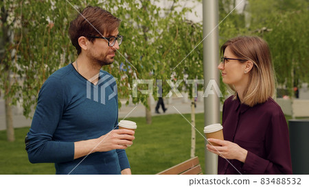 Two colleagues employees discussing planning during break out of office. Two colleagues employees discussing planning during break out of office. 83488532