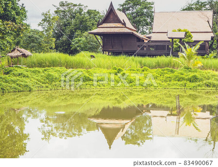 old wooden Traditional Thai-style stilt house on a canal near River in Thailand  . 83490067