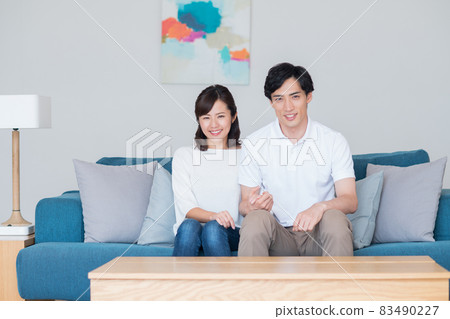 Young newlyweds relaxing in the living room Young newlyweds relaxing in the living room 83490227