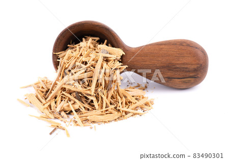 Muira Puama herbal tea in wooden spoon, isolated on white background. Natural potency wood, medicinal plant, dry tea. Ptychopetalum olacoides. 83490301