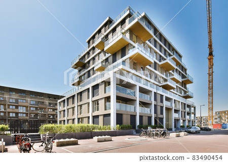 Pretty view of residential building with parking Pretty view of residential building with parking 83490454