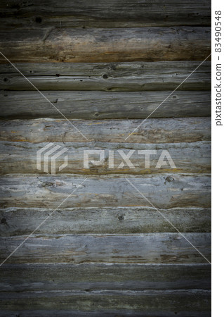 Wooden logs of an old house. Close-up. Weathered natural gray wood texture. Background. vertical photo. Wooden logs of an old house. Close-up. Weathered natural gray wood texture. Background. vertical photo. 83490548