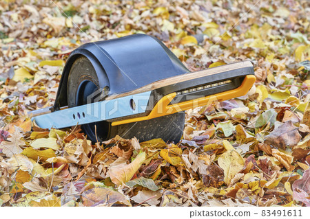 one-wheeled electric skateboard in a backyard 83491611