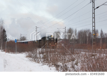 KOUVOLA, FINLAND - DECEMBER 26, 2018: Steam train Ukko-Pekka going from Kouvola to Kotka. The steam locomotive Hr1 1009 was made in 1948 and restored in 1993 KOUVOLA, FINLAND - DECEMBER 26, 2018: Steam train Ukko-Pekka going from Kouvola to Kotka. The steam locomotive Hr1 1009 was made in 1948 and restored in 1993 83491680