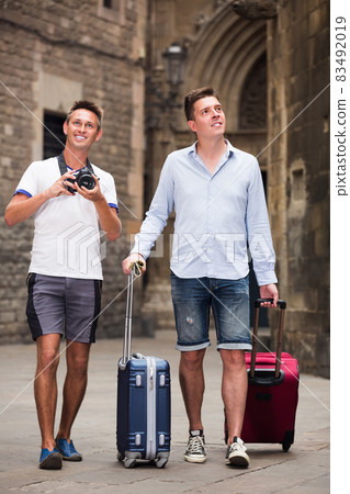 Smiling male tourists making photo outdoors Smiling male tourists making photo outdoors 83492019