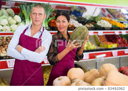 Supermarket workers in uniform standing in salesroom 83492062