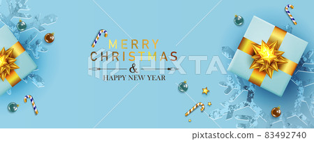 Christmas light blue holiday card, composition with gift box with gold bow. 83492740