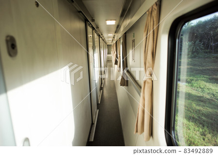 Narrow corridor in front of the room inside the first class train 83492889