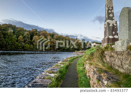 The sun is setting above the Abbey Graveyard which was build by Hugh O Donnell in 1474 - all names and artwork removed 83493377