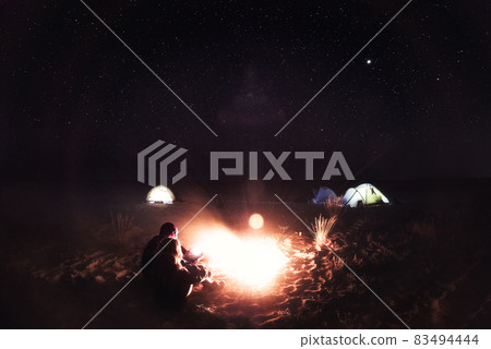 People and fire at night on the beach, Ukraine 83494444