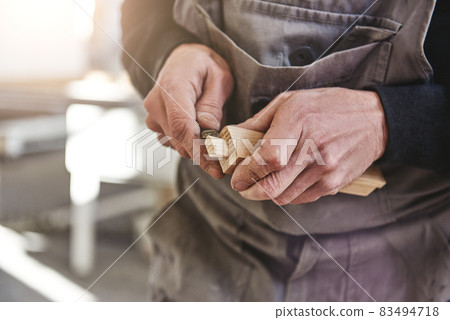 Quality is not an act. It is a habit. Carpenter using chisel to carve wood in workshop Quality is not an act. It is a habit. Carpenter using chisel to carve wood in workshop 83494718