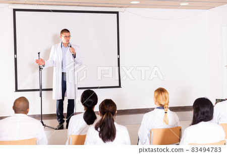 Male coach giving speech at conference hall Male coach giving speech at conference hall 83494783