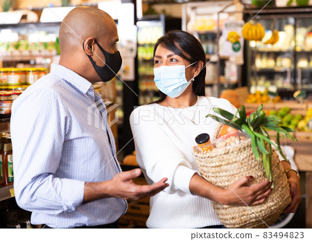 Portrait of couple in protective mask in grocery supermarket Portrait of couple in protective mask in grocery supermarket 83494823