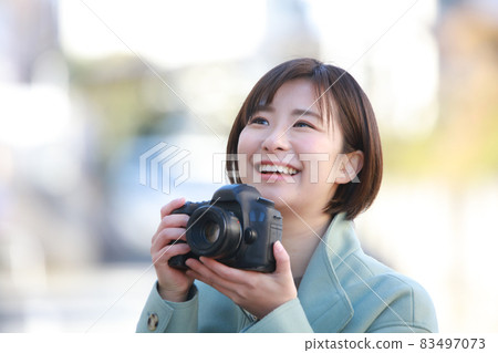 A woman taking a picture 83497073