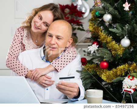 Couple shopping online at home Couple shopping online at home 83497156