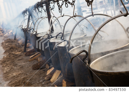 Preparation of food in boilers on an open fire in a traditional style Preparation of food in boilers on an open fire in a traditional style 83497330
