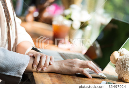 Closeup woman holding her wrist pain from using computer. Office 83497924