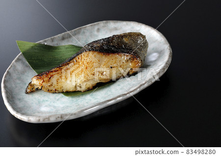 A black background shot of sablefish grilled with fat and a delicious grilled sablefish A black background shot of sablefish grilled with fat and a delicious grilled sablefish 83498280