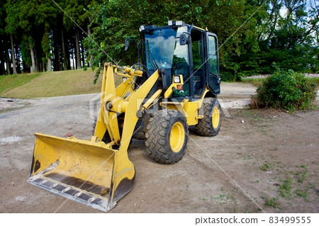 Wheel loader (tire excavator) on the autumn hill on a sunny day 83499555