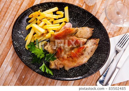 Roasted pettitoes with fried potatoes and fresh greens 83502485