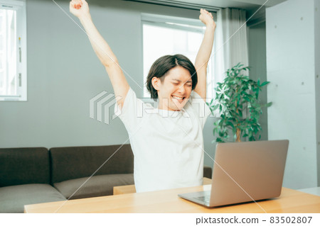 A man stretching in front of a laptop 83502807