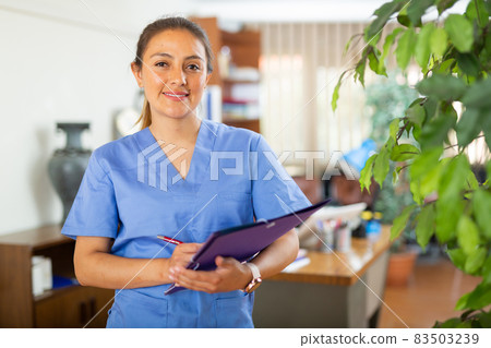 Confident woman doctor standing in office Confident woman doctor standing in office 83503239