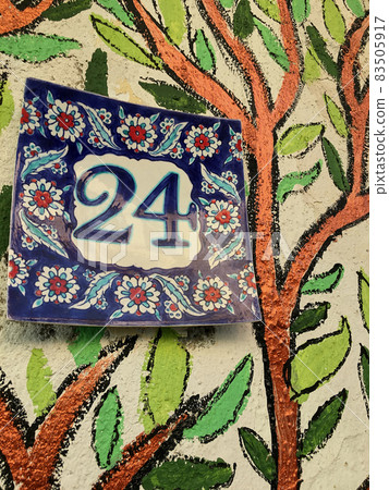 Close up of an house door number 24 83505917