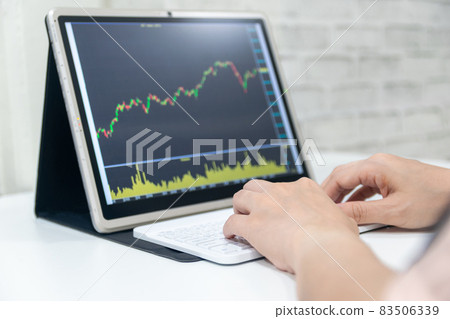 A business examines the financial graph of sales growth on the computer A business examines the financial graph of sales growth on the computer 83506339