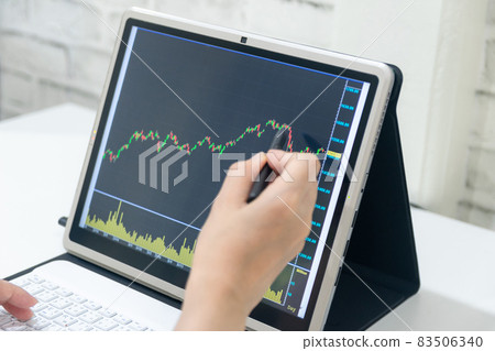A business examines the financial graph of sales growth on the computer A business examines the financial graph of sales growth on the computer 83506340