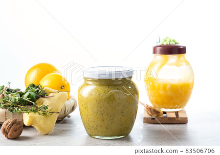 Jar with honey and lemon on a white background. Ginger and lemon, grated with honey. Jam on a white background. 83506706