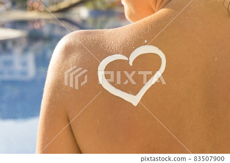Woman with heart shaped sun cream Woman with heart shaped sun cream 83507900