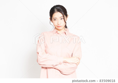 Woman in angry pose in front of white background Woman in angry pose in front of white background 83509018