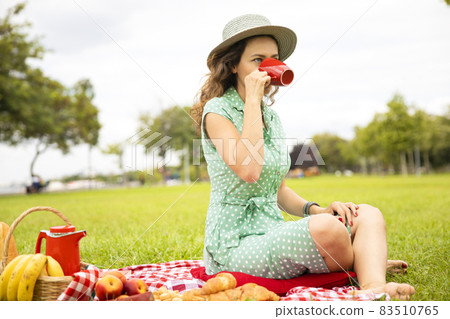 Beautiful young woman having picnic. Beautiful young woman having picnic. 83510765