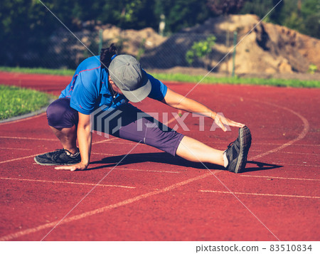 Woman stretching musles and tendons before reguler afternoon run. Woman stretching musles and tendons before reguler afternoon run. 83510834