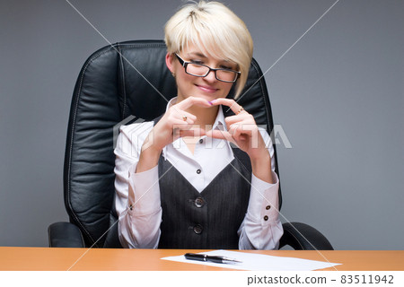Young business lady in office showing gesture Young business lady in office showing gesture 83511942