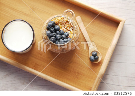 cereal breakfast and blue berry in bowl on table  83512576