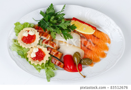 Top view of dish with fish snack on white background 83512676