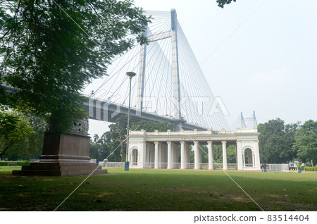 Prinsep Ghat architecture Landscape against Howrah Bridge in background and park on foreground, famous for its Greek or Gothic structure. Kolkata west Bengal India Asia Pacific 21 October, 2021 Prinsep Ghat architecture Landscape against Howrah Bridge in background and park on foreground, famous for its Greek or Gothic structure. Kolkata west Bengal India Asia Pacific 21 October, 2021 83514404