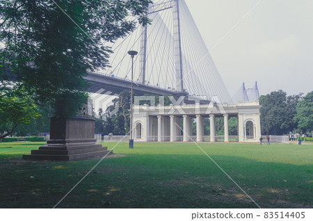 Prinsep Ghat architecture Landscape against Howrah Bridge in background and park on foreground, famous for its Greek or Gothic structure. Kolkata west Bengal India Asia Pacific 21 October, 2021 Prinsep Ghat architecture Landscape against Howrah Bridge in background and park on foreground, famous for its Greek or Gothic structure. Kolkata west Bengal India Asia Pacific 21 October, 2021 83514405