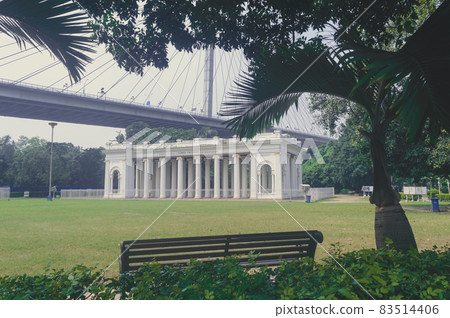 Prinsep Ghat architecture Landscape against Howrah Bridge in background and park on foreground, famous for its Greek or Gothic structure. Kolkata west Bengal India Asia Pacific 21 October, 2021 Prinsep Ghat architecture Landscape against Howrah Bridge in background and park on foreground, famous for its Greek or Gothic structure. Kolkata west Bengal India Asia Pacific 21 October, 2021 83514406